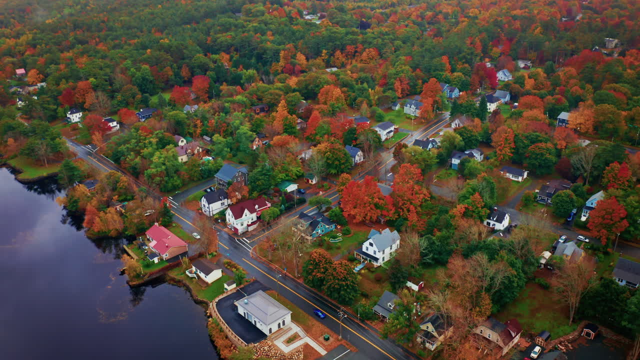 Aerial drone shot over a local town next to a river in Nova Scotia, Canada.
Bird's eye view over the autumn landscape. Colorful trees foliage.