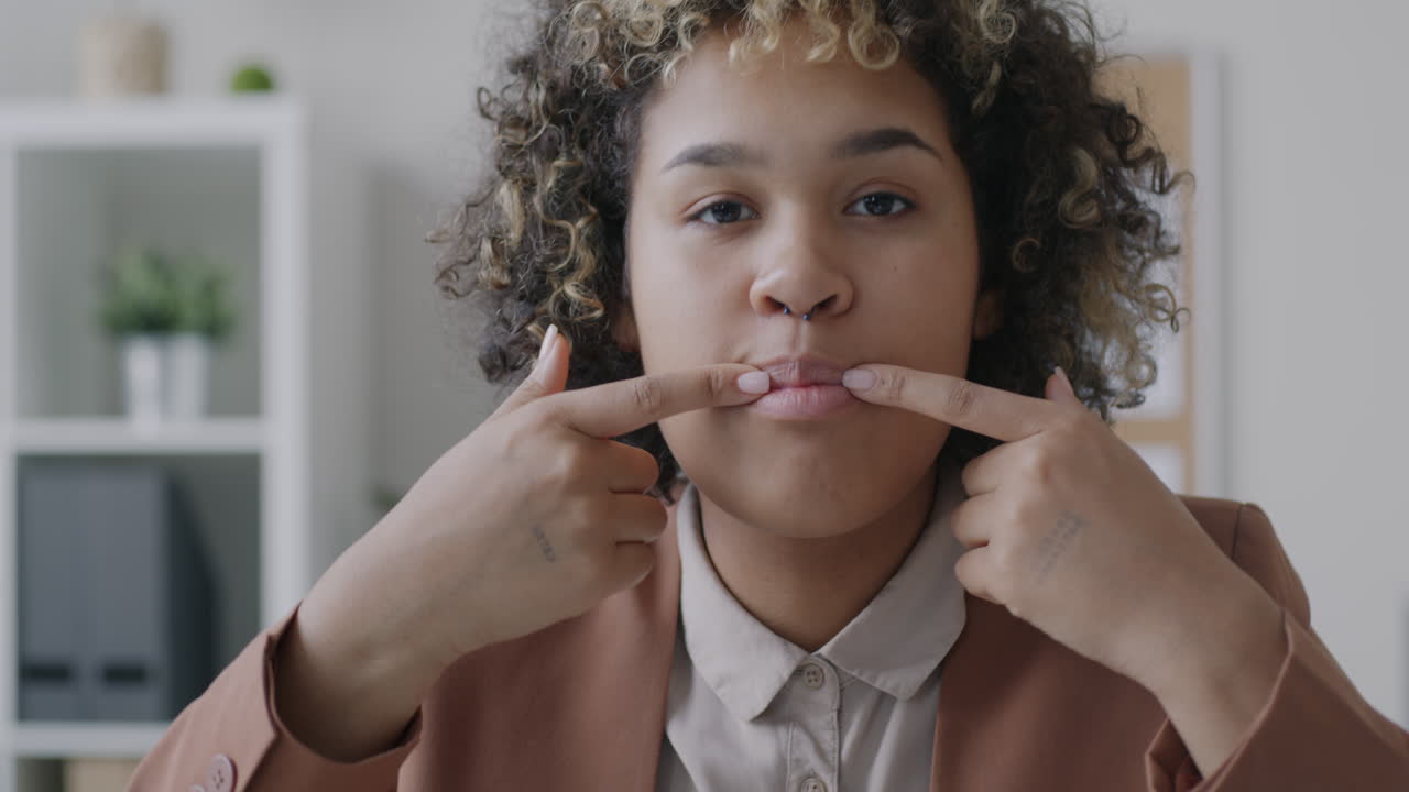 Woman Performing Facial Exercise in Office