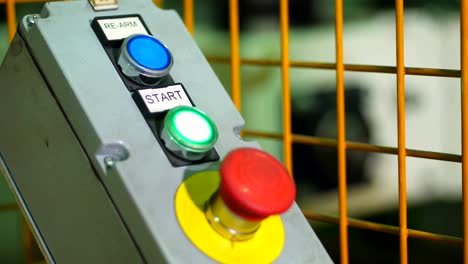 close-up, start or stop red button for industrial machine, emergency stop for safety concept. red emergency stop switch and green reset button in factory . the image of industrial equipment