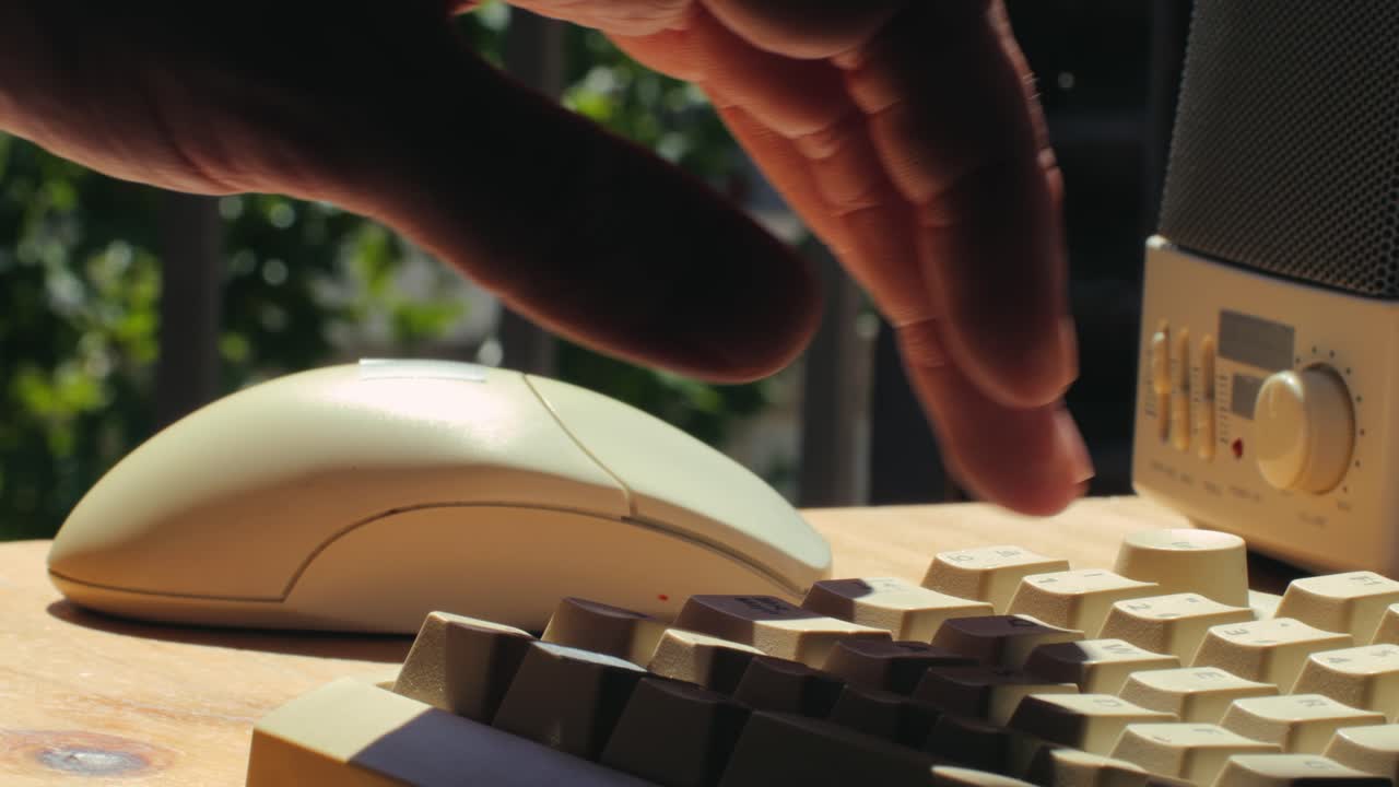 Vintage Computer Setup with Hand on Keyboard