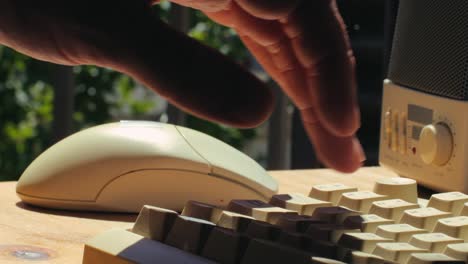 vintage computer setup with hand on keyboard