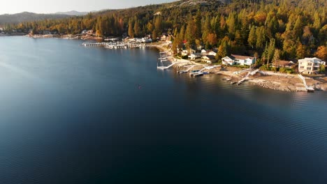 aerial shot of homes on a beautiful lake during golden hour