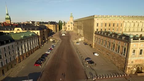an aerial view pulls away from the royal palace in stockholm sweden to show boats docked nearby
