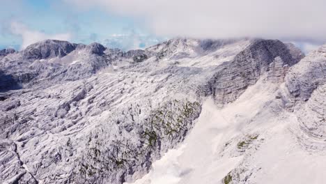 AERIAL-Side-Panning-Shot-of-a-Dramatic-Limestone-Mountain-Landscape-High-Up-in-the-Alps