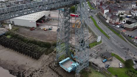 historic industrial newport transporter bridge platform connection over river usk aerial birdseye rising shot