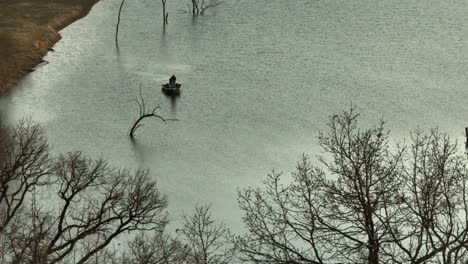 isolated view of a fisherman at lake swepco in arkansas, united states