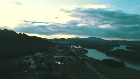 aerial view small tourist town in the mountains under clouds in the twilight near the mountain river