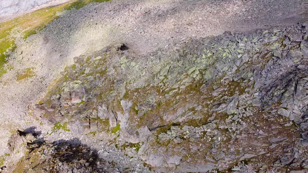 Aerial above sharp rock mountain edge in the swiss alps at the Aletsch Glacier, scenic mountain landscape