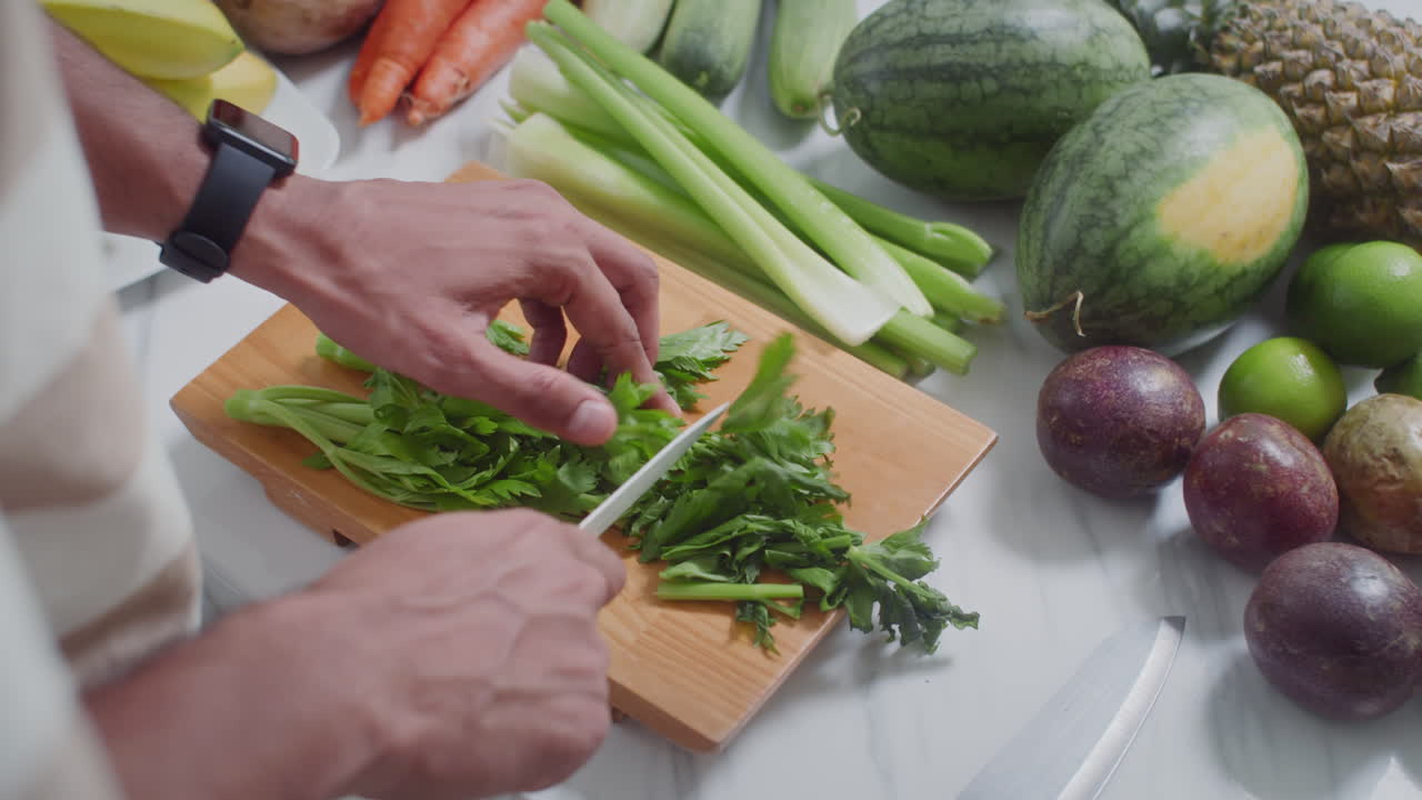 Hands of Cook Cutting Greenery for Salas on Wooden Board