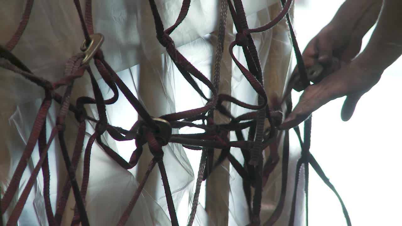 Close-up of hands securing cargo net for safe transportation