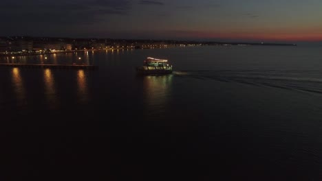 Flying-over-touristic-ship-finishing-night-sea-tour