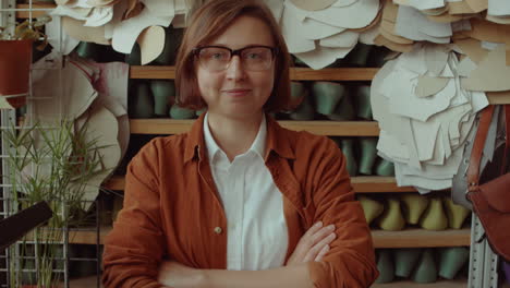 portrait of happy female shoemaker in workshop