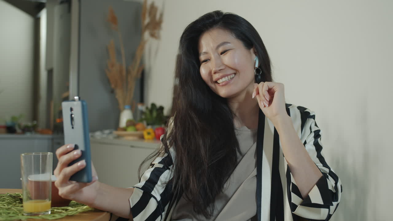 Woman having a video call in the kitchen