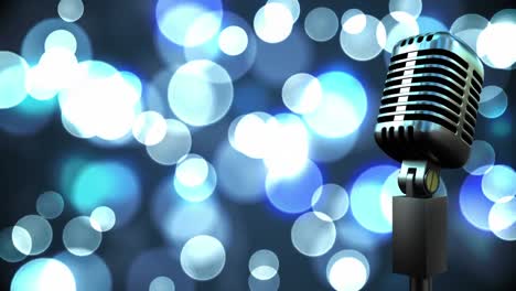 retro metallic microphone against spots of light against blue background