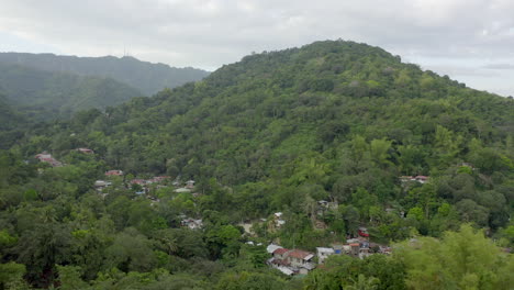 Drone-video-from-above-with-houses-built-in-green-jungle-in-a-Southern-Asia