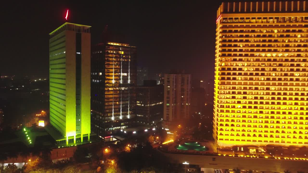 An aerial view with cinematic drone movement of the iconic Marine Drive nightlife with Air India and Trident Hotel buildings in sight.