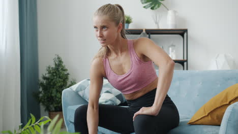 woman doing dumbbell exercises at home