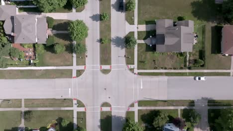 downtown geneseo, illinois with drone video following a car overhead and moving forward