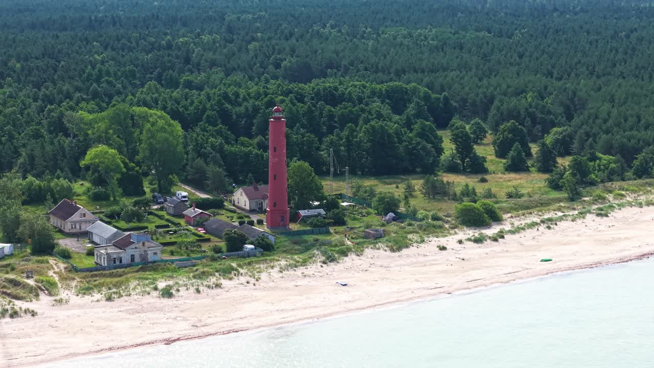 Akmenraga Lighthouse on Baltic Sea Sandy beach Aerial Establishing Shot