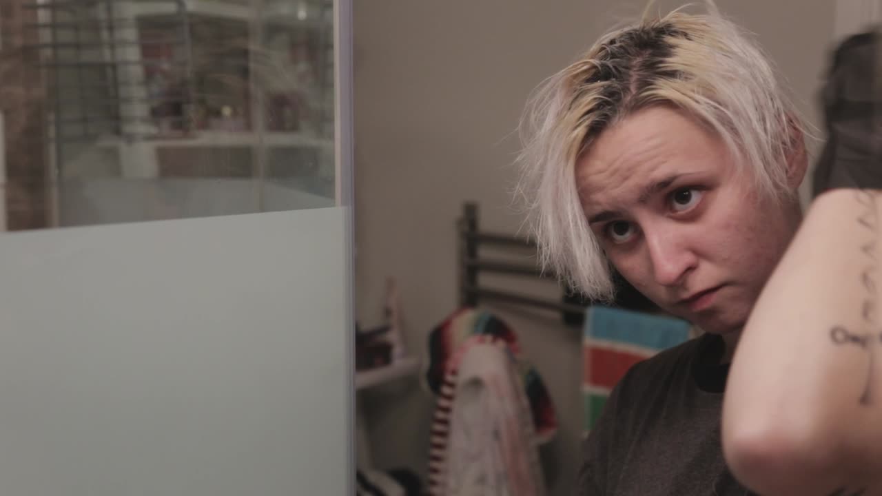 A Young Lady Brushing Her Hair Strands With Her Fingers Before Applying A Hair Bleach - Close Up Shot