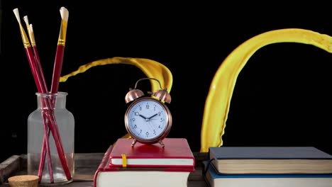 animation of paint splash on black background with books, clock and brushes