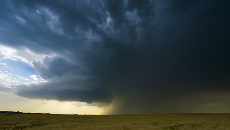 massive supercell thunderstorm over a field