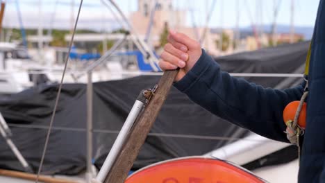 slow motion shot of a captain pulling a leaver on a yacht whilst in the marina