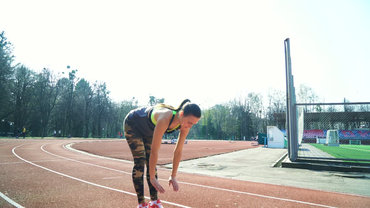 Runner athlete doing exercises at the stadium. Sports shoes. Healthy Lifestyle