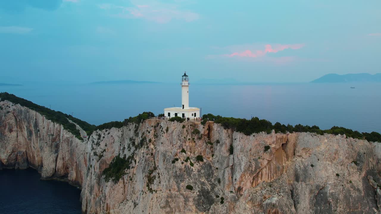 Aerial View Of Douk&aacute;to Lighthouse On Cliff Edge Of Lefkada Island With Misty Landscape Sea In Background
