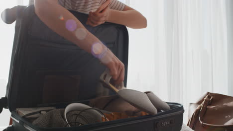 travel woman packing suitcase getting ready for road trip preparing luggage for vacation