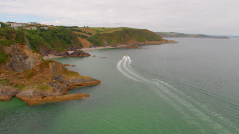 aerial view of cornish coastline and speedboat