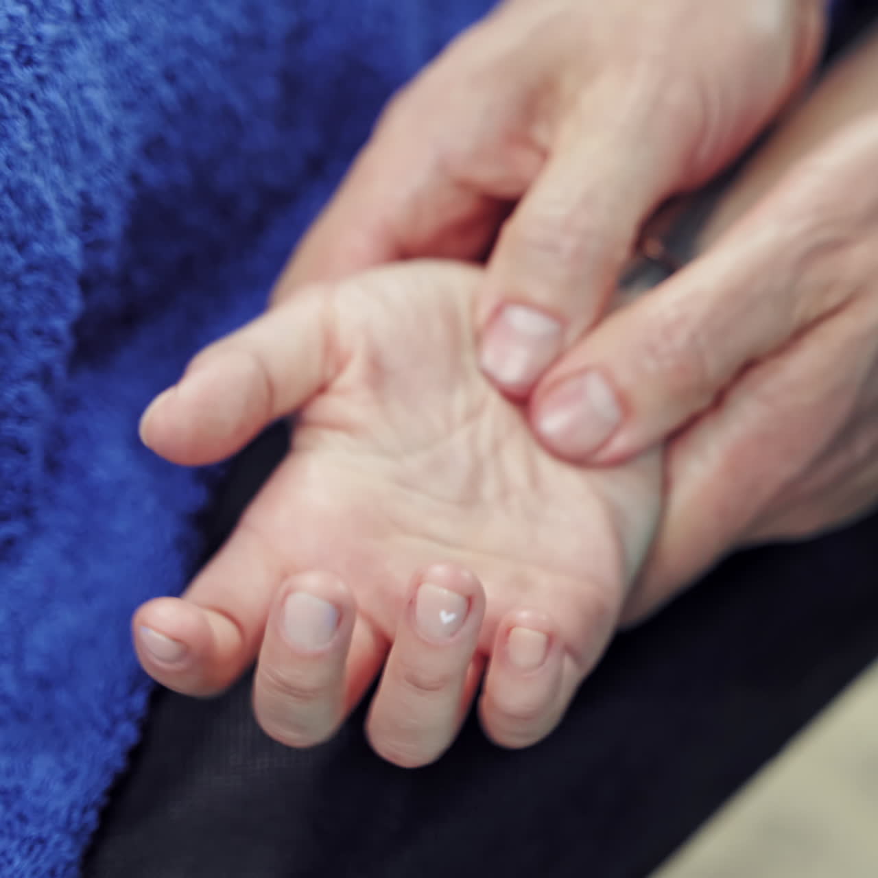 Therapeutic procedure on the female's hand by a professional masseur. Woman client is having acupressure on her hand. Close-up