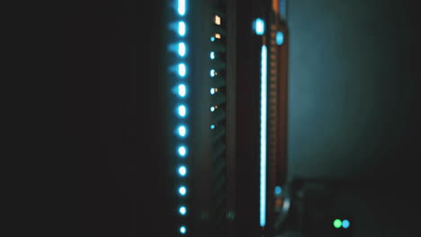 servers illuminated with blue lights in a dark data center during nighttime