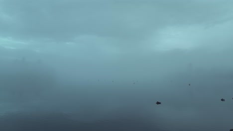 Ducks-Swimming-On-A-Foggy-Lake-Of-Windermere-In-Lake-District,-Cumbria,-England