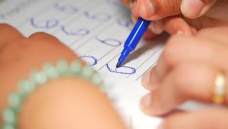 children practicing writing numbers