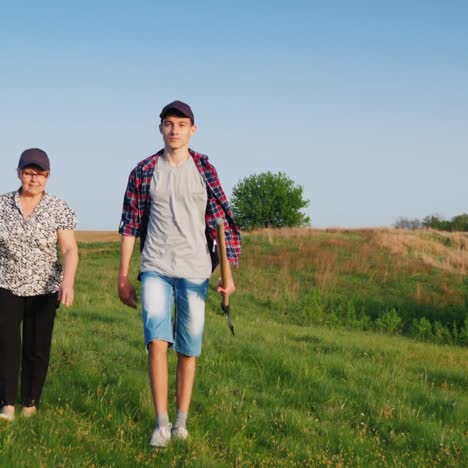 An-Elderly-Woman-With-A-Teenage-Grandson-Is-Going-To-Plant-A-Tree