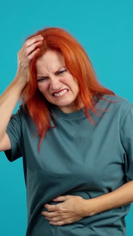 woman suffering from severe headache and stomach pain