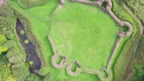 Aerial-video-footage-of-the-remains-of-Bolingbroke-Castle-a-13th-century-hexagonal-castle,-birthplace-of-the-future-King-Henry-IV,-with-adjacent-earthwork