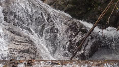 tight shot over beautiful waterfall cascades with heavy water flow