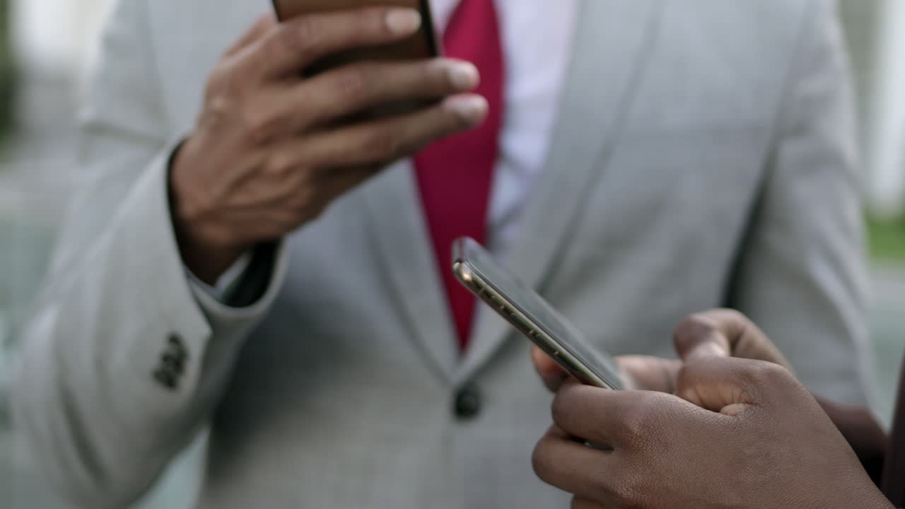 Closeup shot of hands using modern smartphones