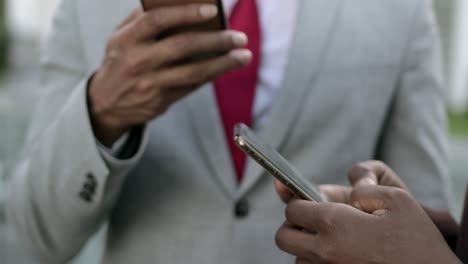 Closeup-shot-of-hands-using-modern-smartphones
