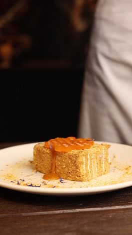 orange-glazed cake slice being served