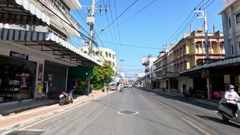 a bustling city street with passing vehicles