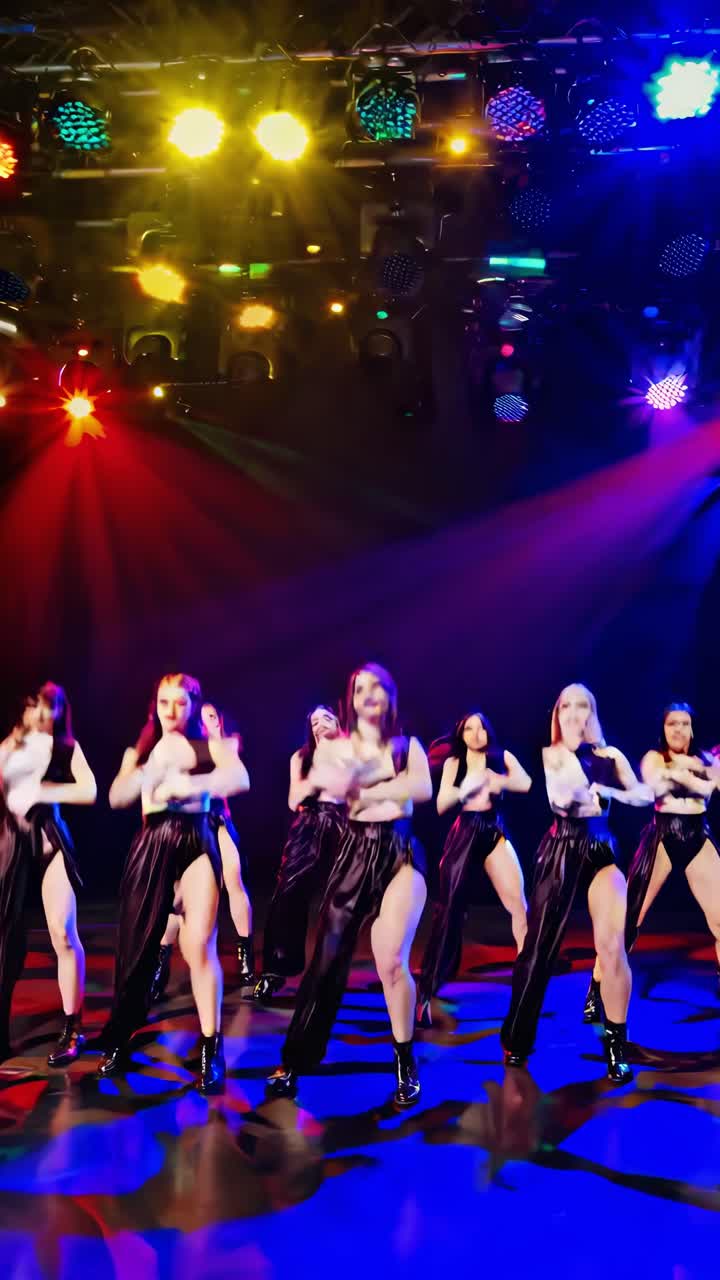 Group of female dancers wearing stage costumes, energetically ...