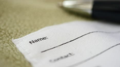 blank clothing name tag with pen