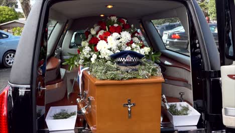 closeup shot of a funeral casket in a hearse or chapel or burial at cemetery