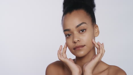 portrait beautiful african american woman touching face with hands caressing smooth healthy skin complexion enjoying perfect natural beauty on white background
