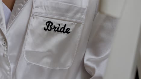 Close-up-slow-motion-shot-of-a-bride-wearing-a-silk-gown-before-the-ceremony