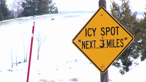 A-Winter-Warning-Sign-For-Drivers-And-A-Bright-Red-Snow-Pole-Are-The-Main-Focal-Points-Of-This-Clip