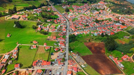 bright daylight reveals guatavita’s red roofs and a charming path winding through the village streets.
